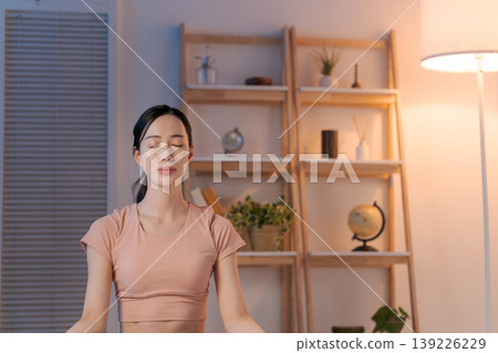 A woman who plays yoga in the room A woman who plays yoga in the room 139226229