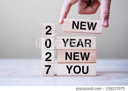 hand holding wooden block with text 2027 NEW YEAR NEW YOU on table background. Resolution, strategy, goal, business and holiday concepts hand holding wooden block with text 2027 NEW YEAR NEW YOU on table background. Resolution, strategy, goal, business and holiday concepts 139227075