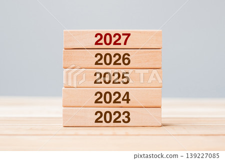 2027 block over 2026 and 2025 wooden building on table background. Business planning, Risk Management, Resolution, strategy, solution, goal, New Year New You and happy holiday concepts 2027 block over 2026 and 2025 wooden building on table background. Business planning, Risk Management, Resolution, strategy, solution, goal, New Year New You and happy holiday concepts 139227085