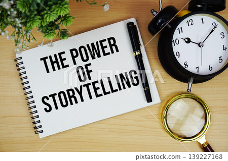 The Power Of Storytelling text written on notepad with alarm clock and magnifying glass flat lay on wooden background 139227168