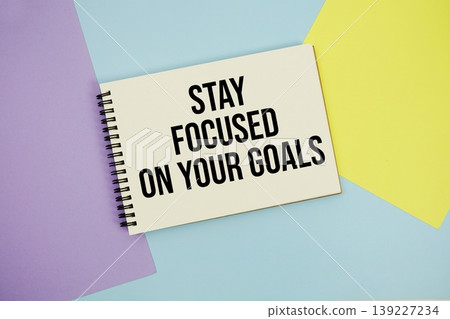 Stay Focused On Your Goals text written on notepad flat lay on multicolor pastel background Stay Focused On Your Goals text written on notepad flat lay on multicolor pastel background 139227234