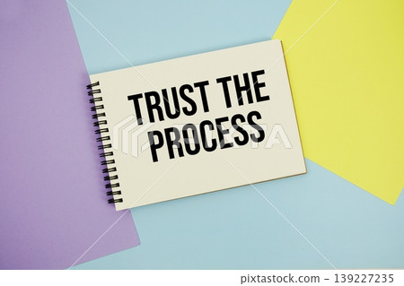 Trust The Process text written on notepad flat lay on multicolor pastel background Trust The Process text written on notepad flat lay on multicolor pastel background 139227235