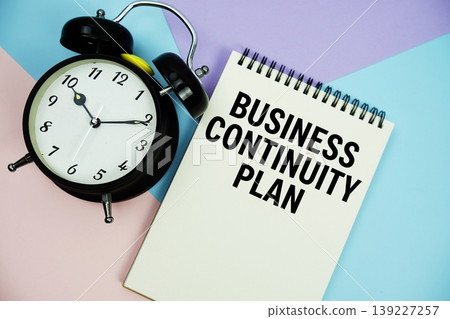 Business Continuity Plan text written on notepad with alarm clock flat lay on multicolor pastel background Business Continuity Plan text written on notepad with alarm clock flat lay on multicolor pastel background 139227257