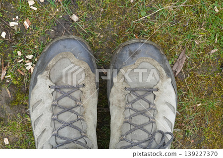 Rugged hiking shoes on a pathway, ready for adventure and exploration in nature's embrace 139227370