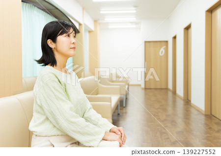 一位女士在醫院候診室等待醫生預約時的側臉——醫院候診室場景。 139227552