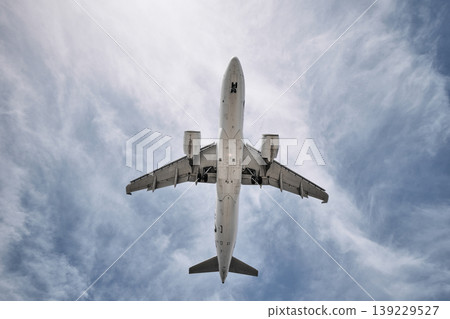 A huge passenger plane is landing in airport of Phuket, Thailand, a bottom view A huge passenger plane is landing in airport of Phuket, Thailand, a bottom view 139229527