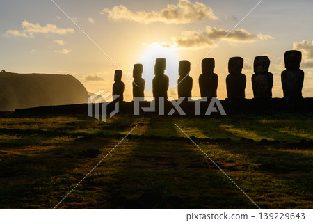 Majestic silhouette of moai statue during easter island chile sunset Majestic silhouette of moai statue during easter island chile sunset 139229643