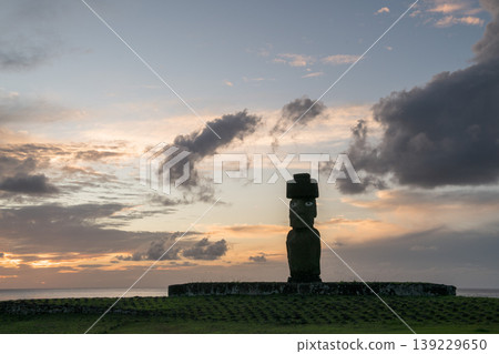 Stoic moai statue standing on easter island chile at peaceful sunset Stoic moai statue standing on easter island chile at peaceful sunset 139229650