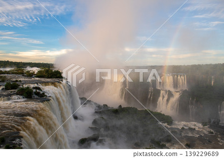 Majestic iguazu falls creating breathtaking mist and colorful rainbow 139229689