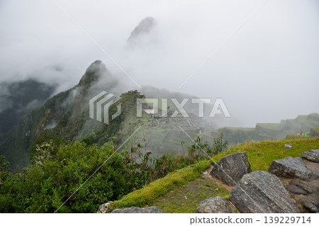 Awe inspiring mysterious foggy mountain landscape of machu picchu ruin Awe inspiring mysterious foggy mountain landscape of machu picchu ruin 139229714
