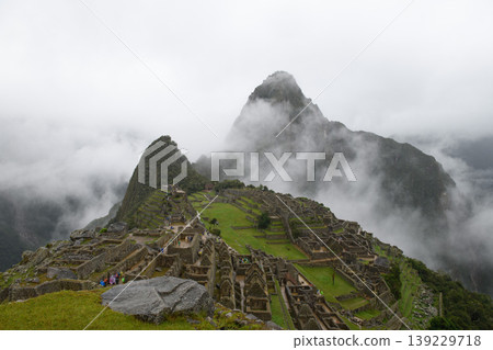 Mysterious machu picchu mountain ruin with thick fog and cloud 139229718