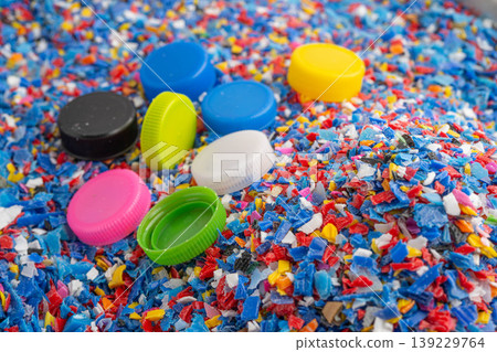 Plastic colorful pieces recycling shredded for industrial use. Plastic colorful pieces recycling shredded for industrial use. 139229764