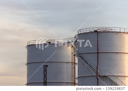 Oil storage tank, White Oil storage fuel tank with oil pipeline system in petrol industry, Oil storage tank at oil and gas refinery industrial zone. Oil storage tank, White Oil storage fuel tank with oil pipeline system in petrol industry, Oil storage tank at oil and gas refinery industrial zone. 139229837