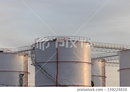 Oil storage tank, White Oil storage fuel tank with oil pipeline system in petrol industry, Oil storage tank at oil and gas refinery industrial zone. Oil storage tank, White Oil storage fuel tank with oil pipeline system in petrol industry, Oil storage tank at oil and gas refinery industrial zone. 139229838