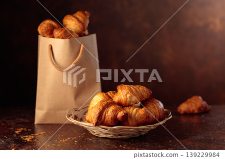Fresh croissants on a brown vintage table. Fresh croissants on a brown vintage table. 139229984