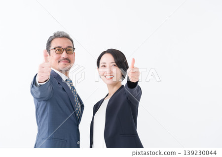 Businessmen in suits giving a thumbs-up Businessmen in suits giving a thumbs-up 139230044