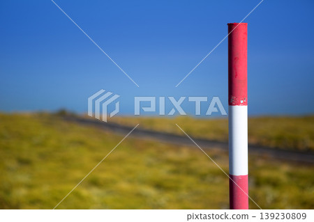 Snow road poles in high mountain blue sky 139230809