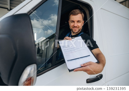 Document to fill out. Courier of delivery service company is sitting in the van Document to fill out. Courier of delivery service company is sitting in the van 139231395
