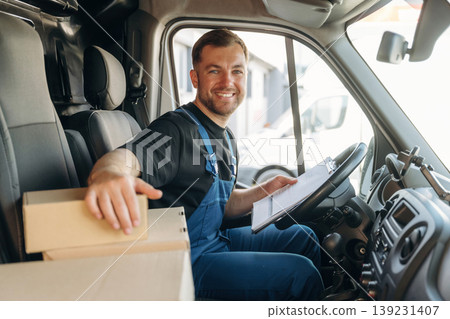 Checking the package. Inside of the bus with delivery service man in uniform Checking the package. Inside of the bus with delivery service man in uniform 139231407