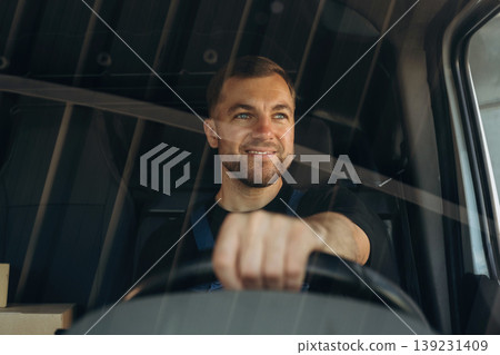 Front view of delivery man that is driving a van Front view of delivery man that is driving a van 139231409