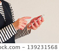 Woman holding a smartphone 139231568
