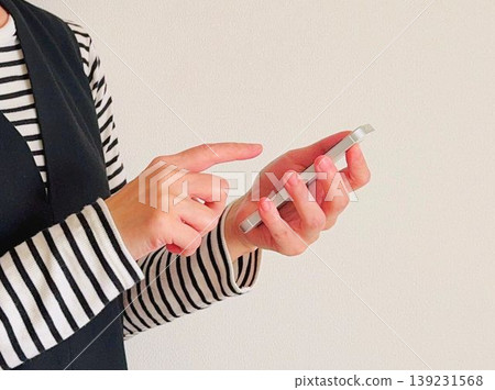 Woman holding a smartphone Woman holding a smartphone 139231568