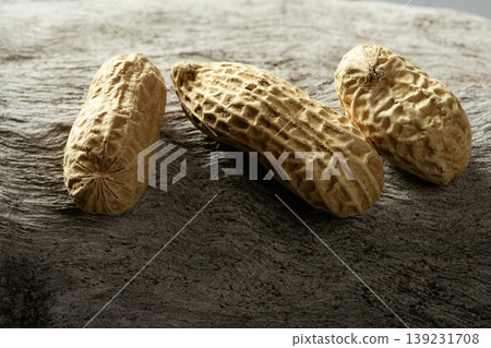 Peanuts macro over wood background Peanuts macro over wood background 139231708