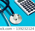 Stethoscope and calculator (blue background) 139232124