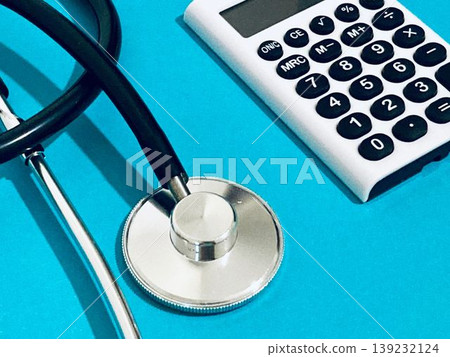 Stethoscope and calculator (blue background) Stethoscope and calculator (blue background) 139232124