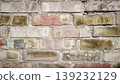 A brownish-beige brick wall. The background is made of brick and has a rough texture 139232129