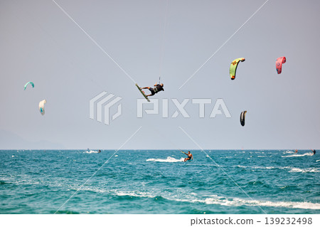 Kitesurfer High Jump Above Sea With City Background Kitesurfer High Jump Above Sea With City Background 139232498
