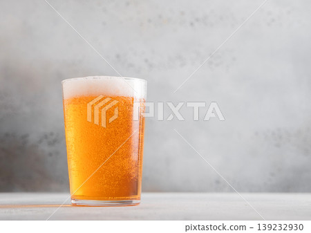 Glass of fresh craft premium lager ale beer on light table background. Glass of fresh craft premium lager ale beer on light table background. 139232930