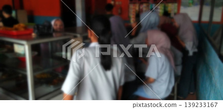 The atmosphere of the school canteen with students queuing to buy food. 139233167