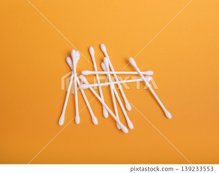 White cotton swabs on an orange background 139233553