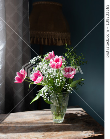 Beautiful bouquet of tulips in glass vase on white marble table. Space for text Beautiful bouquet of tulips in glass vase on white marble table. Space for text 139233565