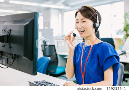 Female operators handling phone calls at a call center Female operators handling phone calls at a call center 139233841