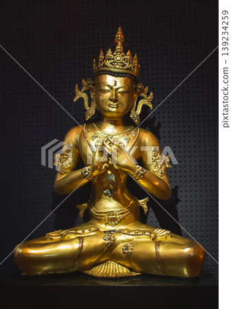 Golden statue of Vajrasattva or a crowned Buddha in meditation Golden statue of Vajrasattva or a crowned Buddha in meditation 139234259