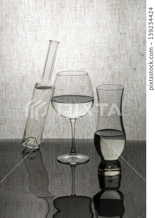 Still life with glassware on a gray background Still life with glassware on a gray background 139234424