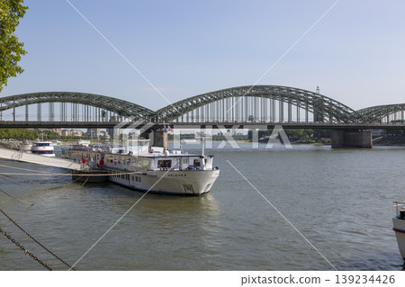 Cologne, Germany - July 07, 2018: View of the Hohenzollern Bridge across the Rhine River in Cologne Cologne, Germany - July 07, 2018: View of the Hohenzollern Bridge across the Rhine River in Cologne 139234426