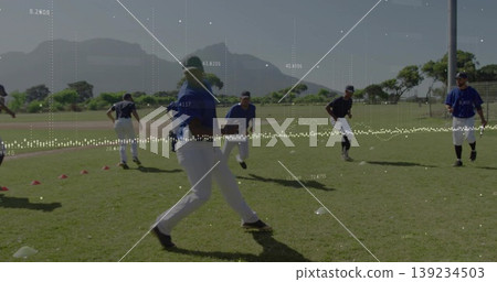 Advancing male player in blue jersey white pants moving across practice field, with training cones Advancing male player in blue jersey white pants moving across practice field, with training cones 139234503