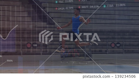 Launching male athlete performing long jump toward sand pit on track in stadium, with data overlay Launching male athlete performing long jump toward sand pit on track in stadium, with data overlay 139234506