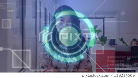 Standing businesswoman in floral blouse projecting interface in open-plan office, coworker typing Standing businesswoman in floral blouse projecting interface in open-plan office, coworker typing 139234509