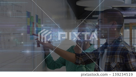 Senior manager in blouse and engineer in plaid examining whiteboard in office, with sticky notes Senior manager in blouse and engineer in plaid examining whiteboard in office, with sticky notes 139234519