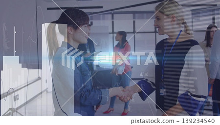 Two women in denim jacket and badge lanyard shaking hands in conference room, with whiteboard Two women in denim jacket and badge lanyard shaking hands in conference room, with whiteboard 139234540