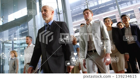 Striding grey-haired leader guiding team in suits through glass atrium with social media overlays Striding grey-haired leader guiding team in suits through glass atrium with social media overlays 139234615
