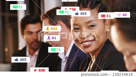 Smiling woman in dark blazer analyzing social media metrics in office, with floating notifications Smiling woman in dark blazer analyzing social media metrics in office, with floating notifications 139234618