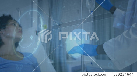 Lying patient watching gloved doctor adjusting IV beside hospital bed with holograms, copy space 139234644