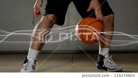 Athlete dribbling basketball at gym, with crew socks, basketball shoes and white wave overlay Athlete dribbling basketball at gym, with crew socks, basketball shoes and white wave overlay 139234664