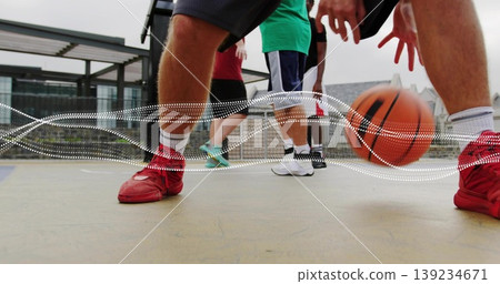 Dribbling basketball player showing legs on rooftop court, with bouncing ball and metal pergola 139234671