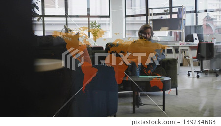 Holding smartphone on sofa in office lounge with coffee table, shelving, map overlay, copy space Holding smartphone on sofa in office lounge with coffee table, shelving, map overlay, copy space 139234683